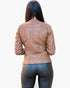 Beach Rose Co. brown faux leather jacket with quilted shoulder detail worn by a woman from the back view