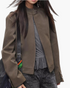 Beach Rose Co. brown faux leather moto jacket with a snap-tab stand collar and zip-front closure on a model