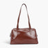 Beach Rose Co. brown faux leather sport bag with a sleek finish, long shoulder straps, and a secure zipper closure.