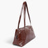 Beach Rose Co. brown faux leather sport bag with a secure zipper closure and shoulder straps on a white background.