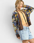 Beach Rose Co. brown knit cardigan with blue, yellow, green floral pattern, V-neck, button front, balloon sleeves, and cropped length.