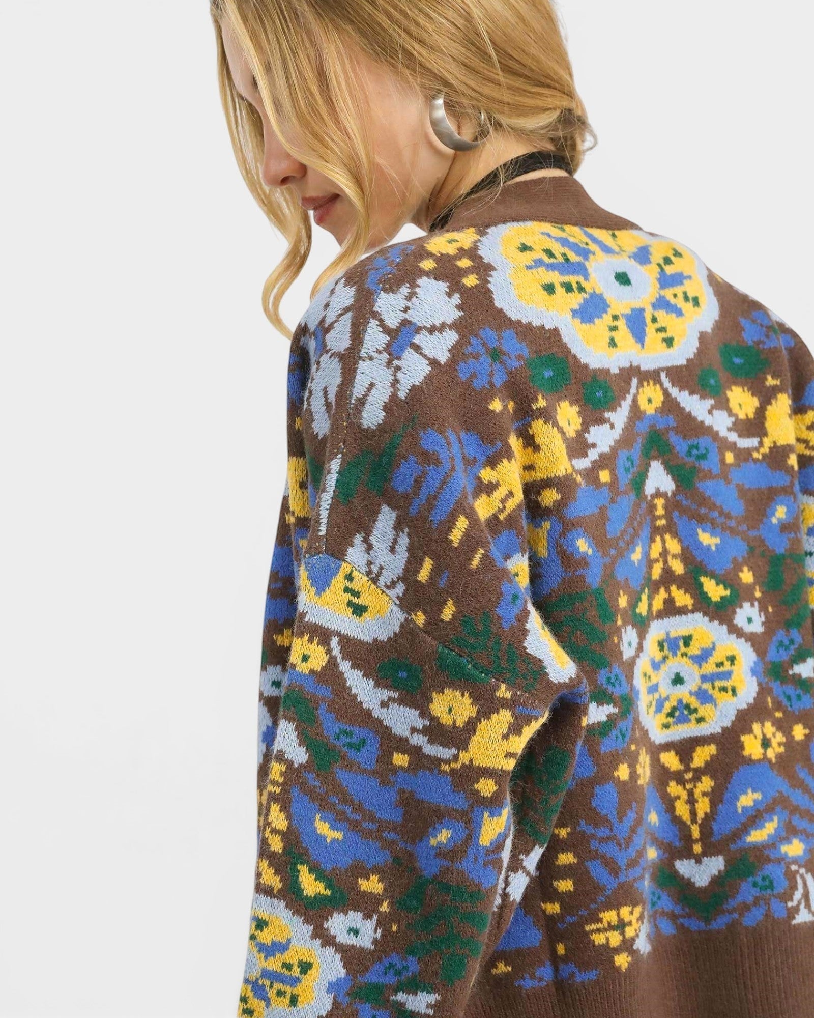Beach Rose Co. brown knit cardigan with blue, yellow, and green floral pattern. Cropped, V-neck, button front, balloon sleeves.