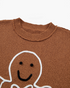 Beach Rose Co. brown crewneck sweater featuring a smiling gingerbread man design with raised white icing details.