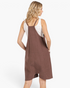 Beach Rose Co. brown relaxed knit romper with wide legs and dropped crotch, worn over a white tank top, back view.