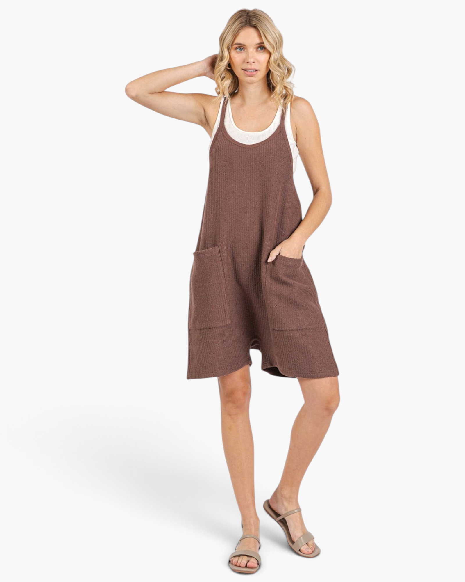 Beach Rose Co. brown relaxed knit romper with wide legs, dropped crotch, and oversized pockets on a blonde model