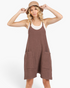 Beach Rose Co. brown relaxed knit romper with wide legs, dropped crotch, and oversized pockets on a blonde model.