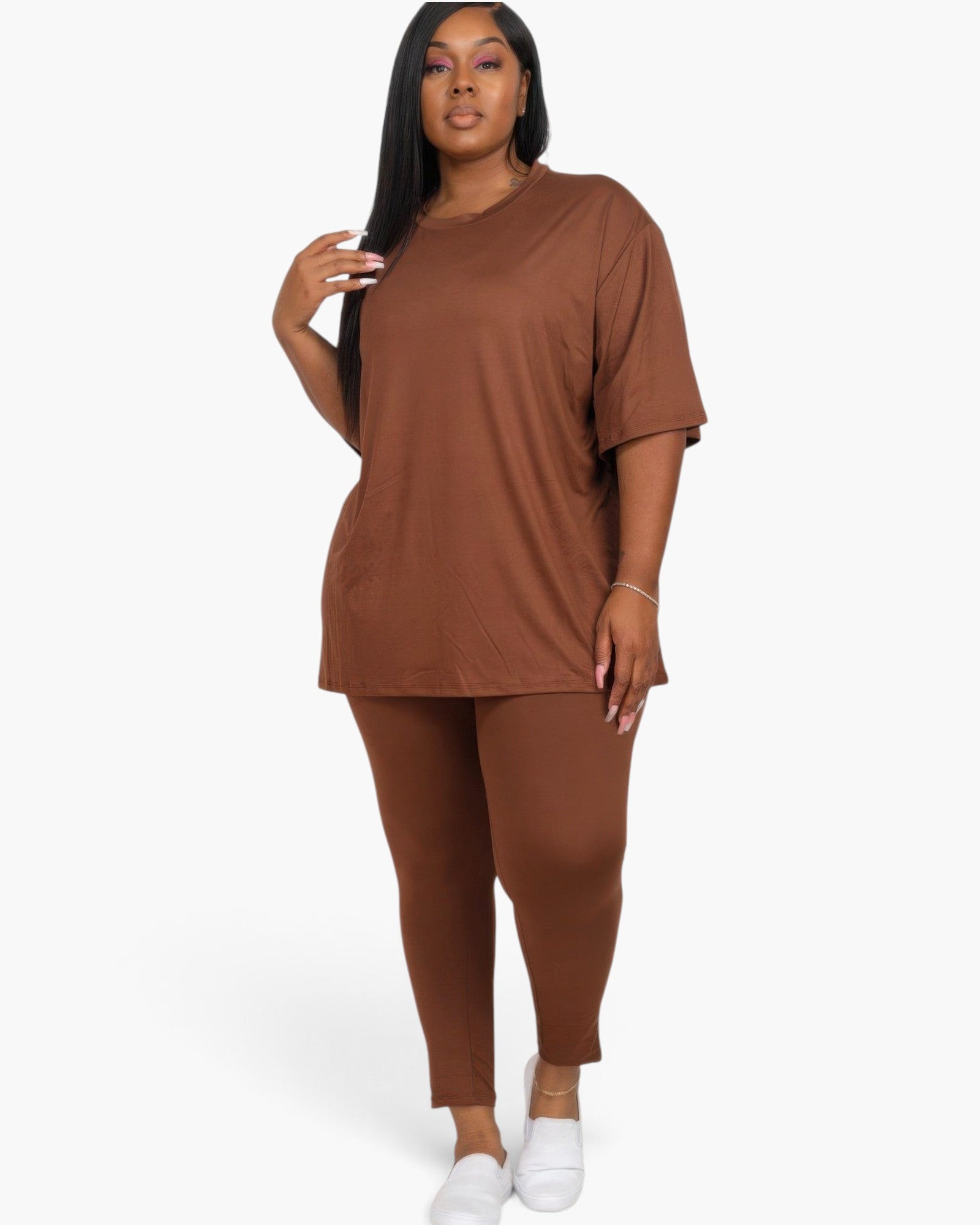 A model wearing a Beach Rose Co. plus size brown oversized t-shirt and matching leggings set with white sneakers.