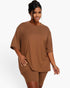 Beach Rose Co. plus size brown loose fit top and biker shorts set on a model with a high bun