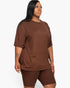Beach Rose Co. plus size model wearing a brown loose fit jersey top and matching biker shorts set.