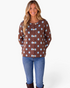 Beach Rose Co. brown cardigan with light blue polka dots, round neck, and button-front worn by a smiling model.
