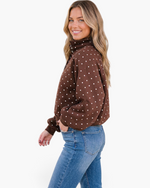 Beach Rose Co. brown polyester pullover with white polka dots, pointed collar, and snap-button neckline on a model.