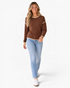 Beach Rose Co. brown long sleeve top with mini polka dots, cream contrast trim, and dropped shoulders on a model.