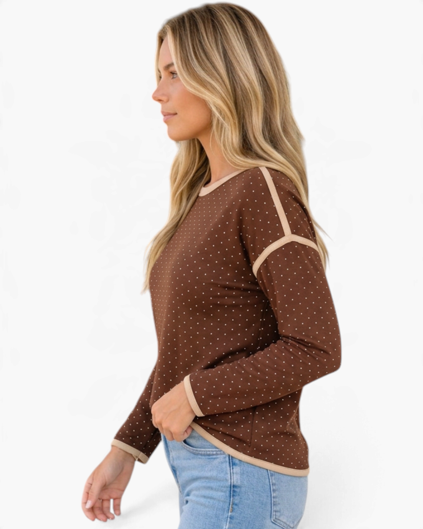 Beach Rose Co. brown long sleeve top with white polka dots, cream contrast trim, and dropped shoulders, side view.