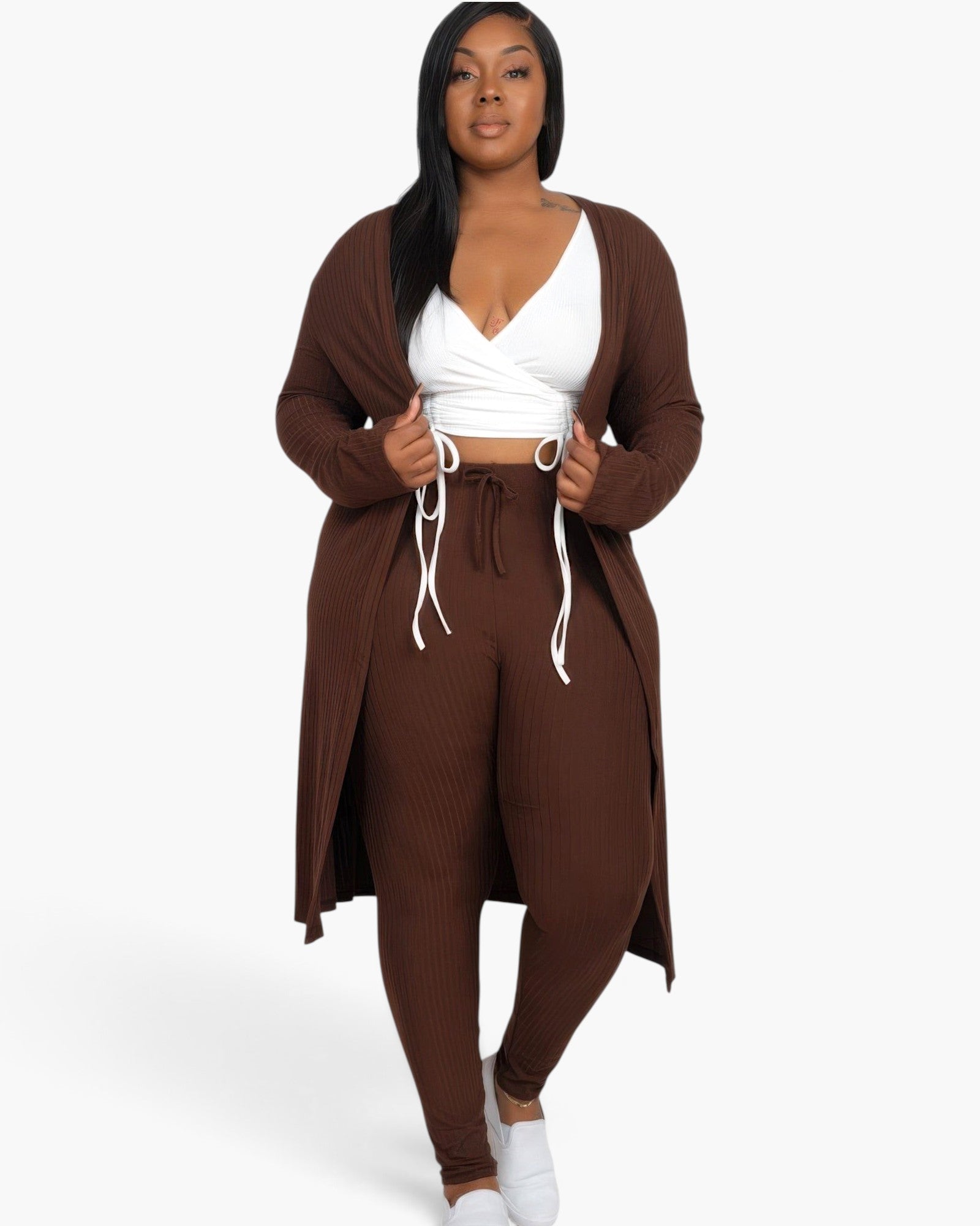 Beach Rose Co. plus size model wearing a brown ribbed long cardigan and matching leggings with a white crop top
