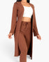 Beach Rose Co. brown ribbed long cardigan and matching leggings set worn with a white crop top on a model