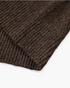 Close-up of the ribbed cuff and hem texture on a brown Beach Rose Co. knit sweater with subtle confetti flecks.