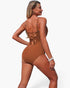 Beach Rose Co. brown one-piece swimsuit with a V-neck, ruched tummy control, and a lace-up back detail on a model.