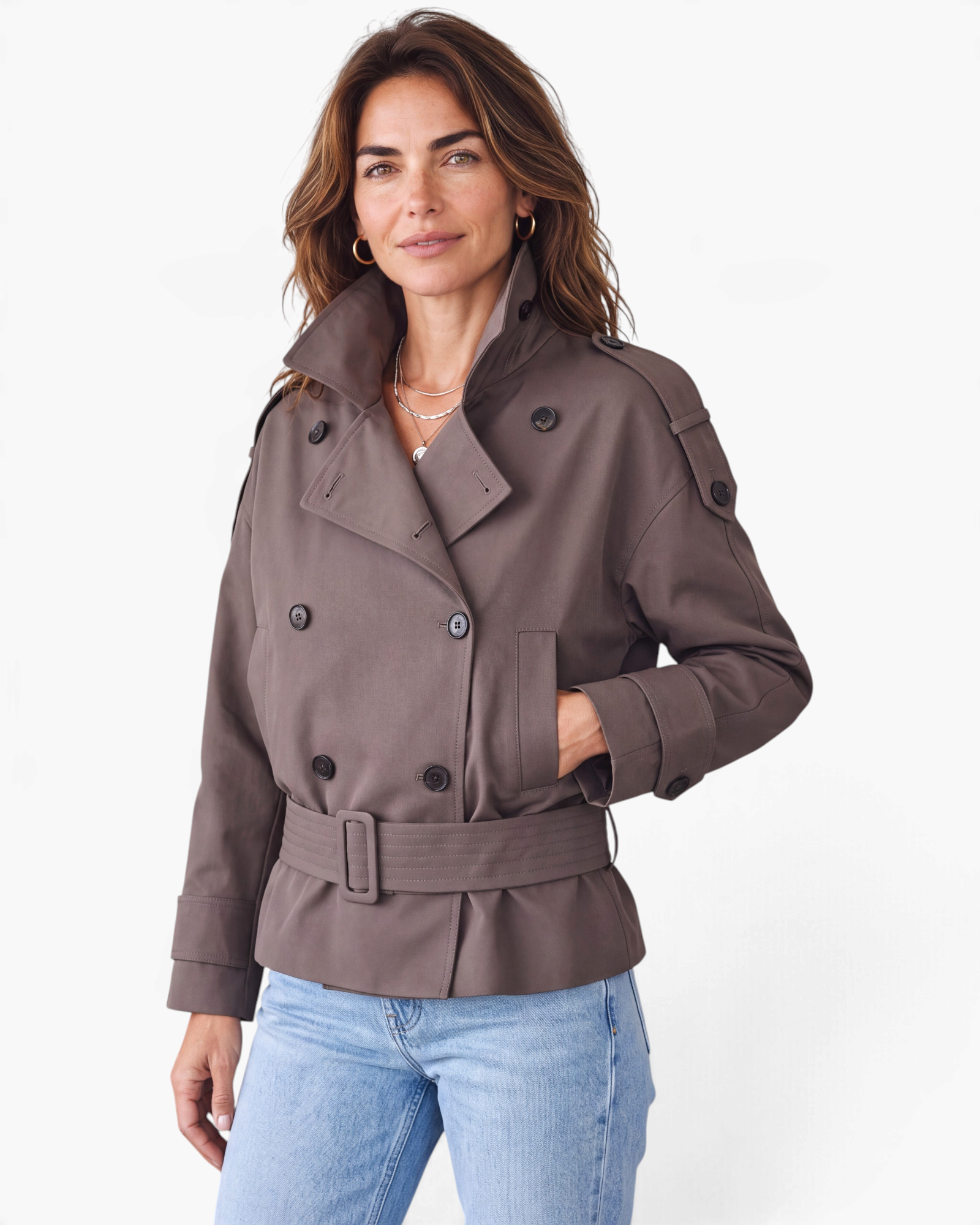 Beach Rose Co. brown short trench jacket with double-breasted buttons, wrap collar, and buckled waist belt on model.