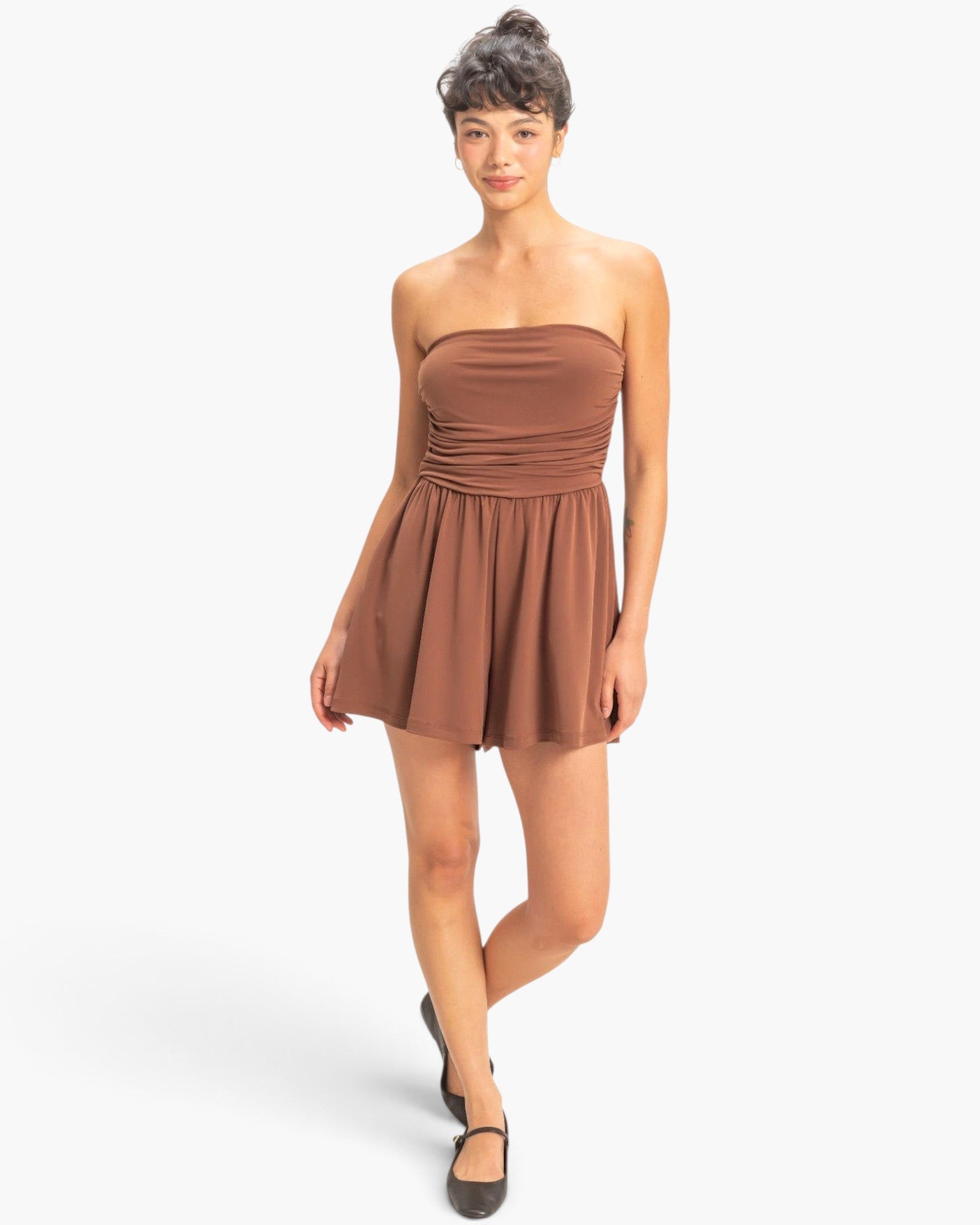 Beach Rose Co. brown strapless romper with shirred waist and relaxed shorts worn by a model on a white background