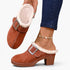 Beach Rose Co. brown suede clogs with fluffy white lining, oversized buckle, and chunky block heel on a model.