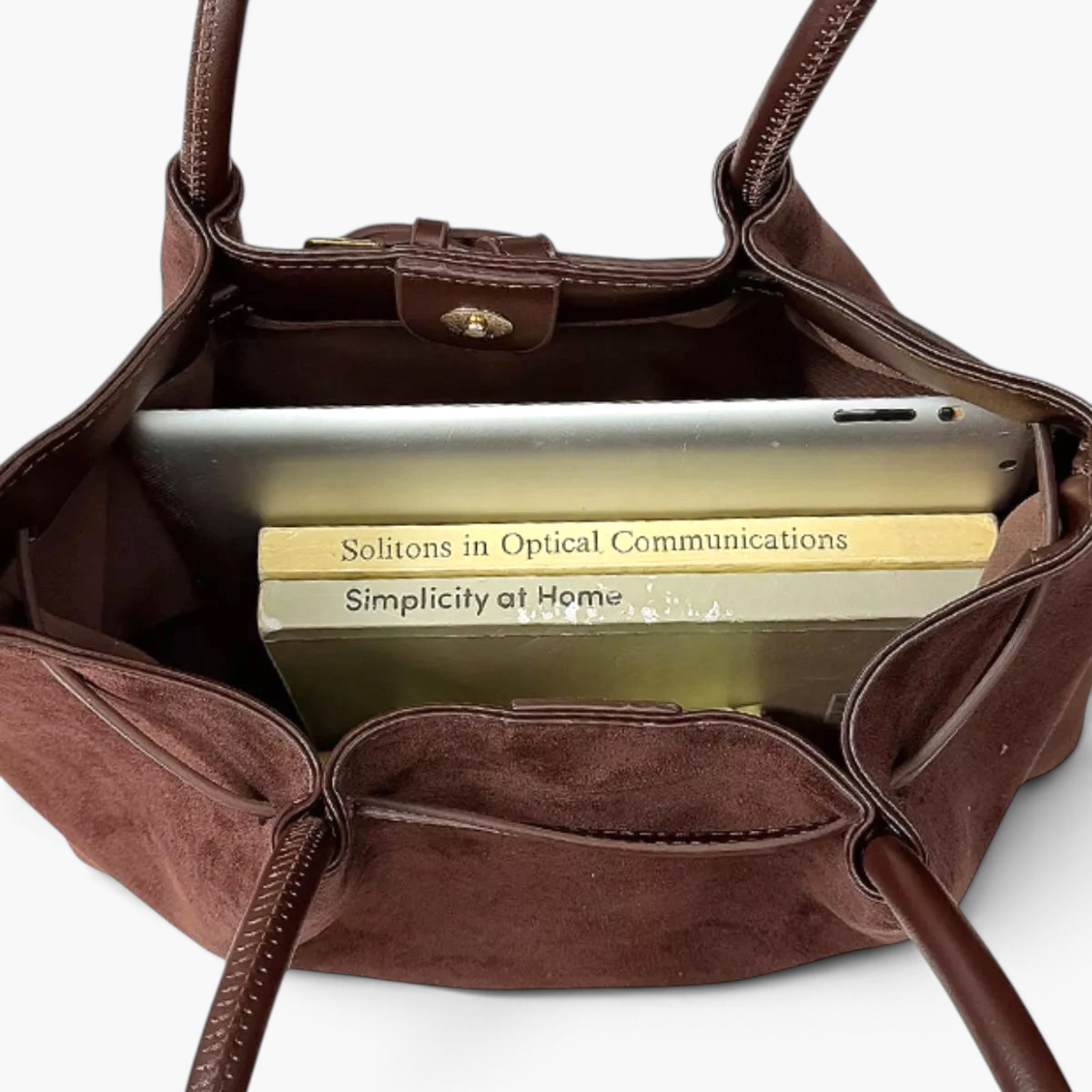 Beach Rose Co. brown suede shoulder bag with double handles, magnetic closure, and books inside for scale.