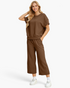 Beach Rose Co. brown two-piece set with a textured short-sleeve top and cropped wide-leg pants on a blonde model.