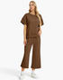 Beach Rose Co. brown two-piece set with short-sleeve top and wide-leg cropped pants in textured geometric fabric.