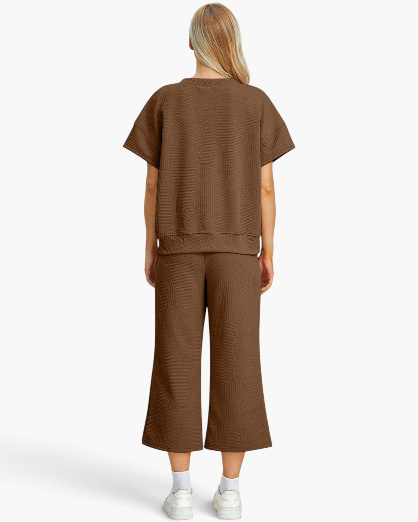 Back view of a woman wearing a Beach Rose Co. brown textured two-piece set with short sleeves and cropped pants.