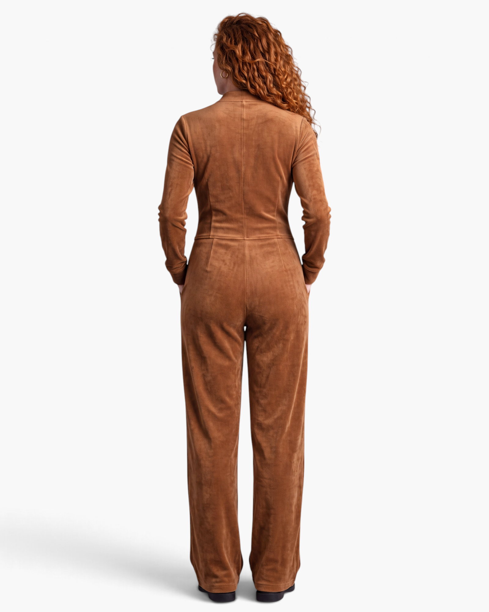 Beach Rose Co. brown velour jumpsuit with long sleeves, wide legs, and side pockets, viewed from the back.