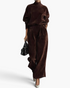 Beach Rose Co. brown velvet two-piece set with a mock neck top and pleated wide leg pants on a model holding a bag.