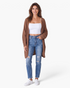 Beach Rose Co. brown waffle knit longline cardigan worn by a woman with a white tank top and distressed blue jeans.