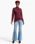 Beach Rose Co. burgundy fitted jacket with mock neck, shoulder snaps, and asymmetrical buckle hem worn by a model.
