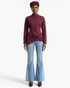 Beach Rose Co. burgundy fitted jacket with mock neck, shoulder snaps, and asymmetrical buckle hem on a model