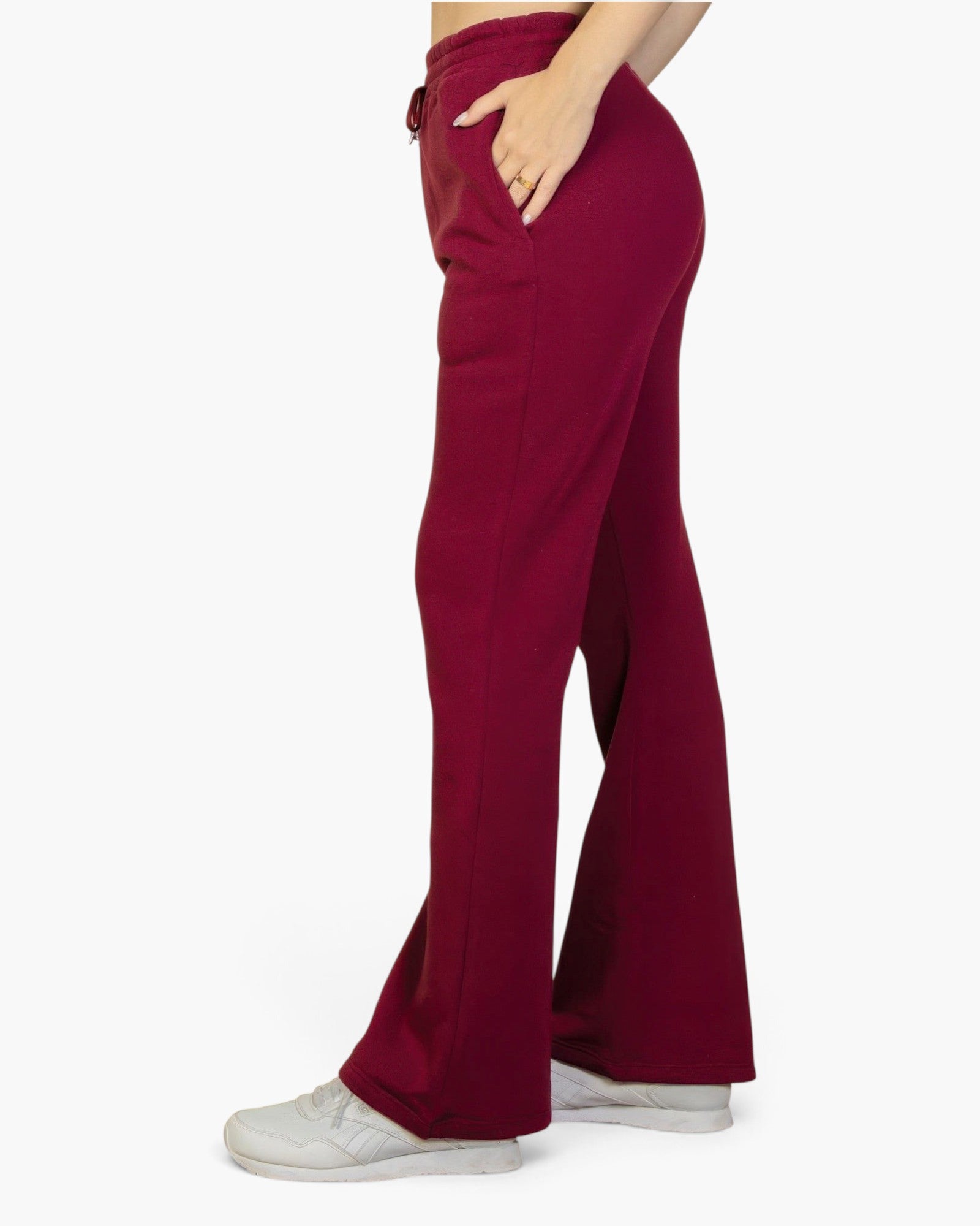 Beach Rose Co. burgundy bootcut sweatpants with a drawstring waist and slant pockets worn with white sneakers.