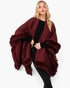 Beach Rose Co. burgundy knit cape with plush faux fur trim and front closure worn by a blonde model