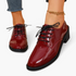 Beach Rose Co. burgundy patent lace-up oxford shoes with a low block heel and round toe worn with cropped jeans