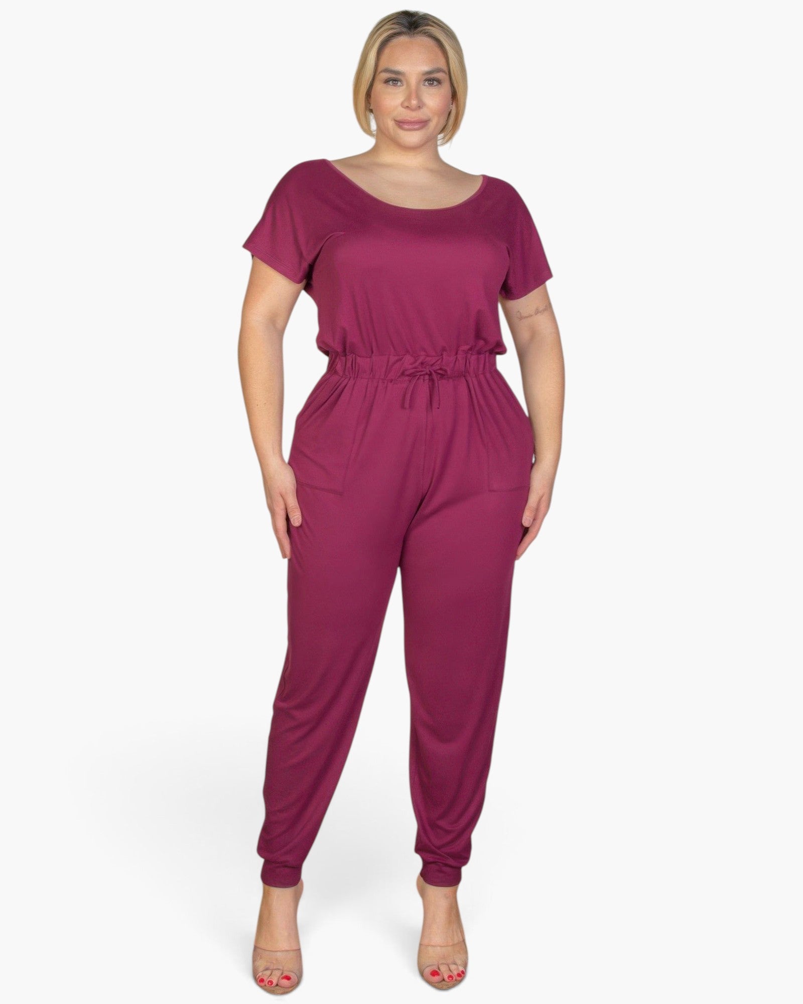 Beach Rose Co. plus size burgundy short sleeve jumpsuit with a drawstring waist, worn by a blonde model.
