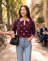 Beach Rose Co. burgundy knit sweater with blush polka dots, scalloped collar, and pearl buttons worn with jeans.