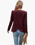 Beach Rose Co. burgundy quilted crewneck pullover with back button detail and ruffled hem worn with blue jeans