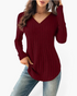 Beach Rose Co. burgundy ribbed long sleeve knit top with a wide V-neckline and curved hem worn with blue jeans.