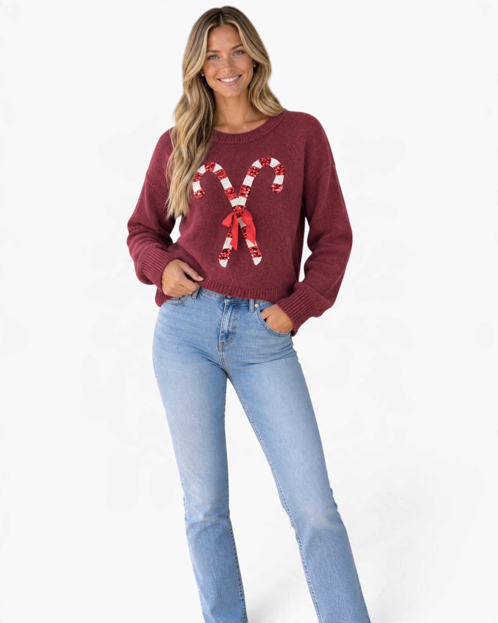 Beach Rose Co. burgundy crewneck sweater with sequin candy cane design and ribbon bow worn by a smiling model