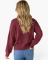 Back view of a woman wearing a Beach Rose Co. burgundy crewneck sweater with long sleeves and ribbed trim.
