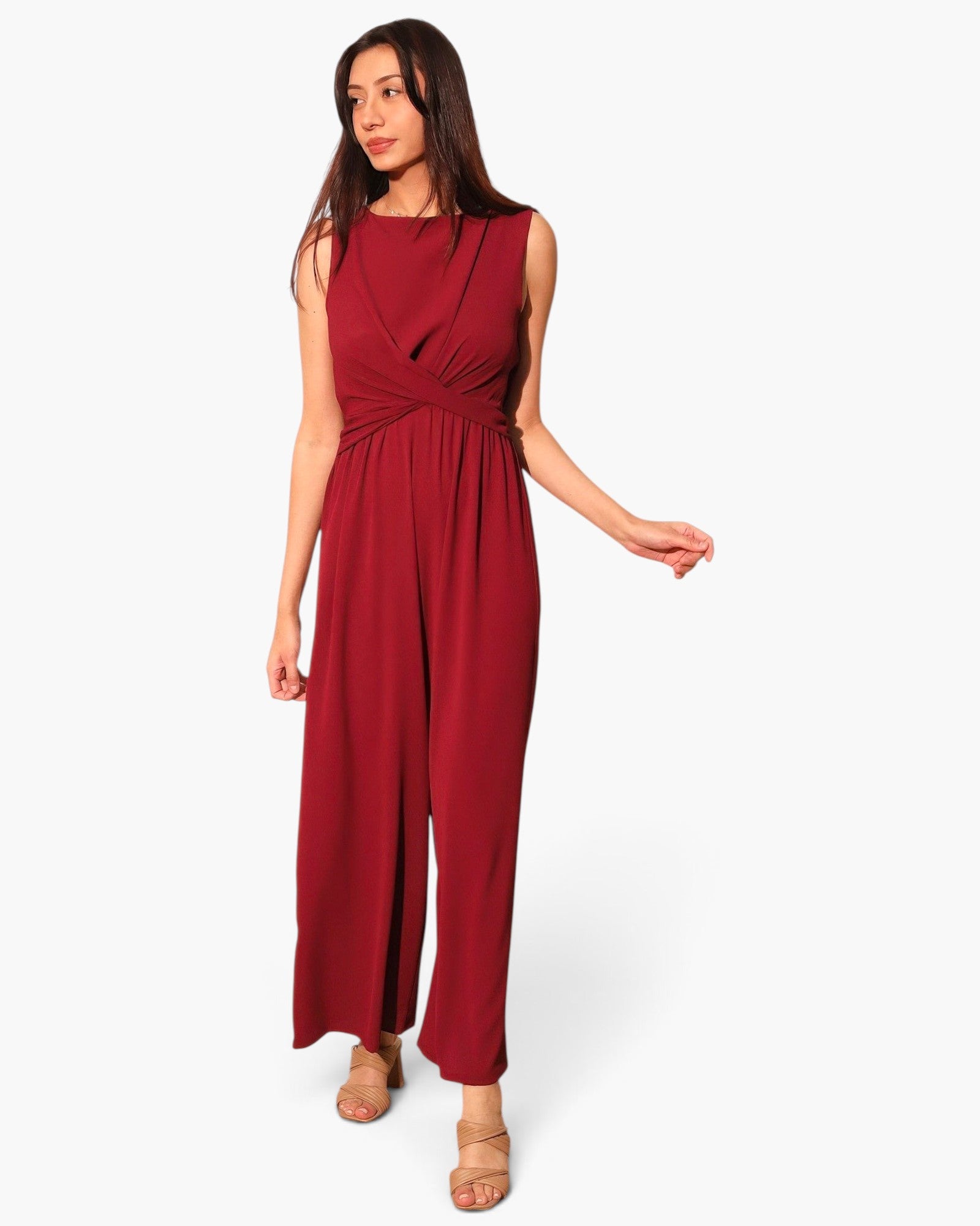 Beach Rose Co. model wearing a sleeveless burgundy textured jumpsuit with a twist-front waist and wide-leg trousers.