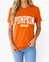 Beach Rose Co. burnt orange short-sleeve tee with white collegiate-style Pumpkin Season graphic on a woman