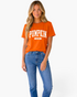 Beach Rose Co. burnt orange short-sleeve tee with white collegiate Pumpkin Season graphic worn by a blonde model