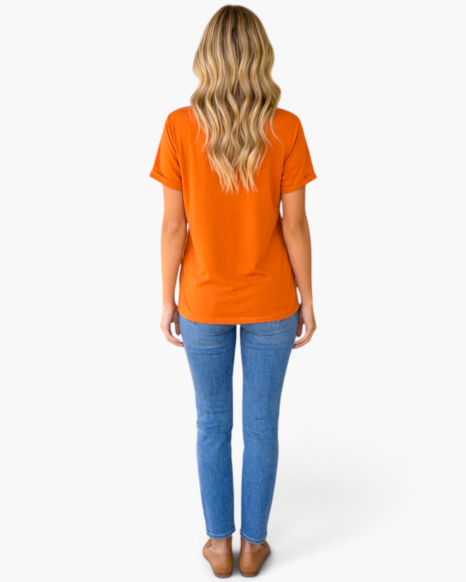 Beach Rose Co. burnt orange short sleeve tee worn by a blonde woman with blue jeans, back view