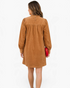 Beach Rose Co. camel corduroy mini dress with puff sleeves and gathered back yoke, back view on a model