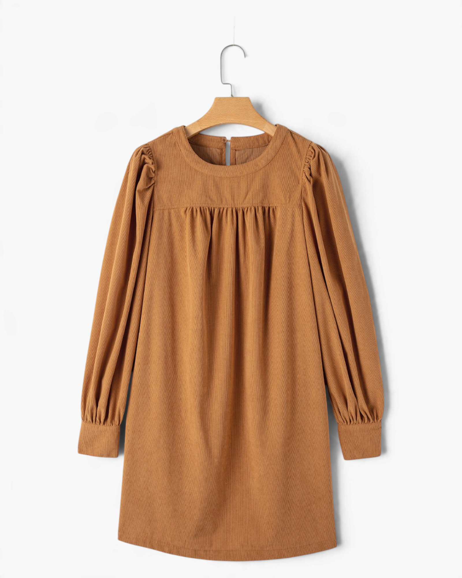 Beach Rose Co. camel corduroy mini dress with puff sleeves, gathered yoke, and round neckline on a wooden hanger.