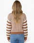 Beach Rose Co. camel and cream striped knit sweater with dropped shoulders and ribbed trim, back view on a model.