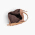 Beach Rose Co. camel faux suede bindle bag with a brown interior lining and adjustable leather strap